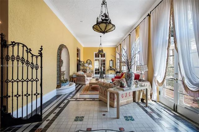 a living room with fireplace furniture and a large window