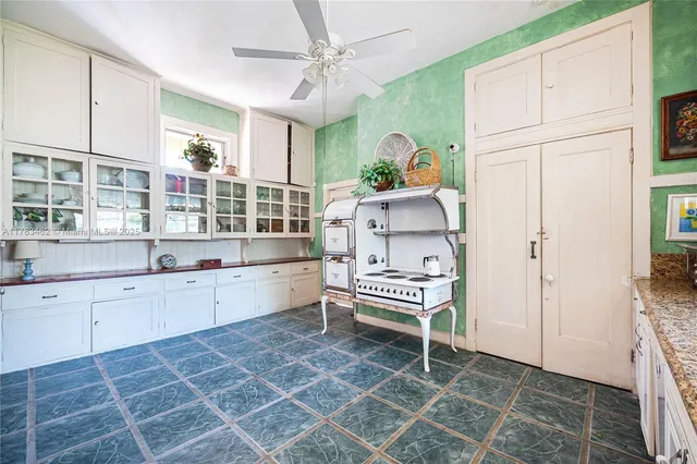 a room with white cabinets and window