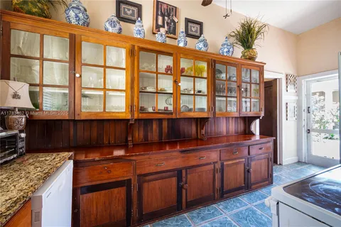 a view of a dining room with furniture a chandelier and wooden floor
