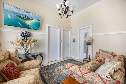 a living room with fireplace furniture and a chandelier