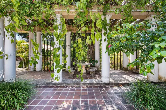 a patio view with a table and chairs and potted plants