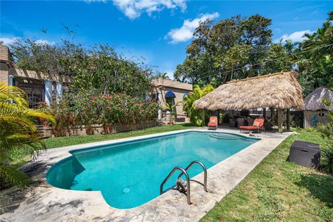 a view of a field of grass and trees