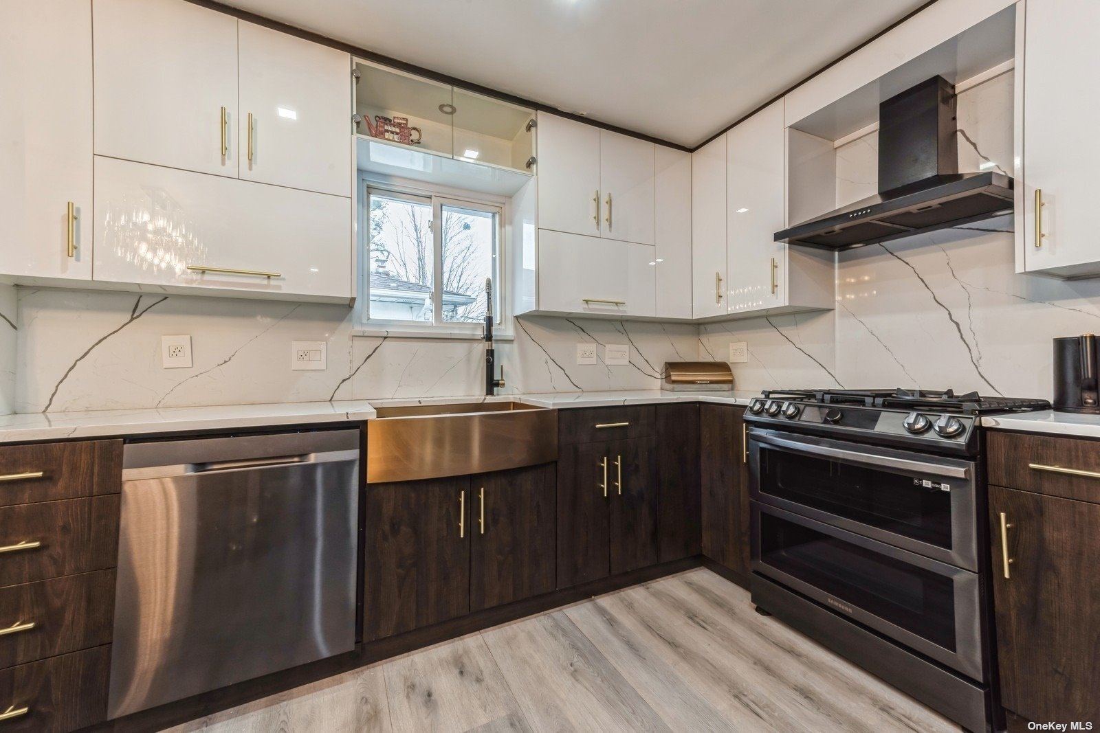 a kitchen with stainless steel appliances granite countertop a sink a stove and a microwave