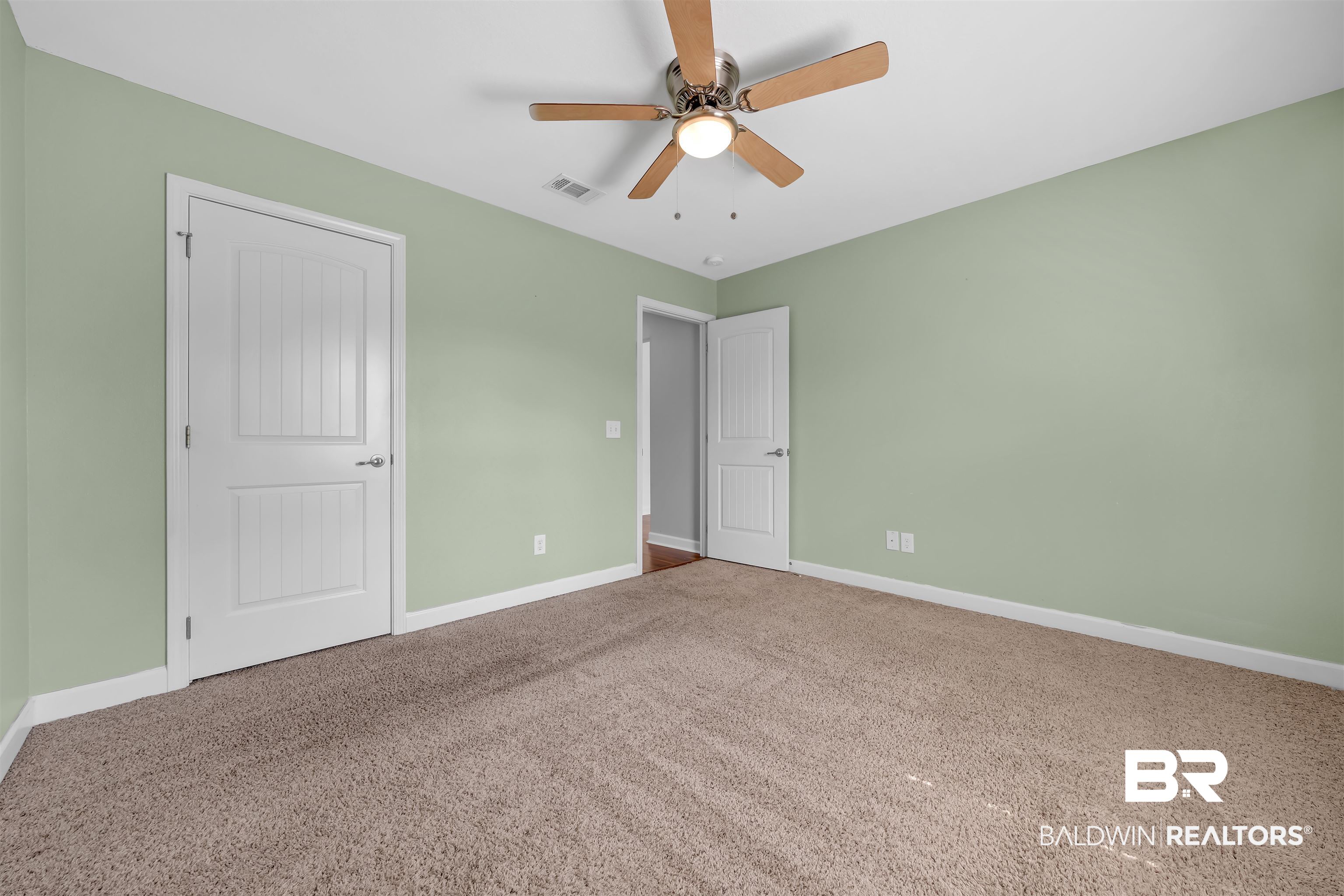 10147 Lyttleton Loop Lillian, AL 36549 - Photo 24 of 29 Carpeted room featuring light green walls, white trim, and a ceiling fan with light fixture