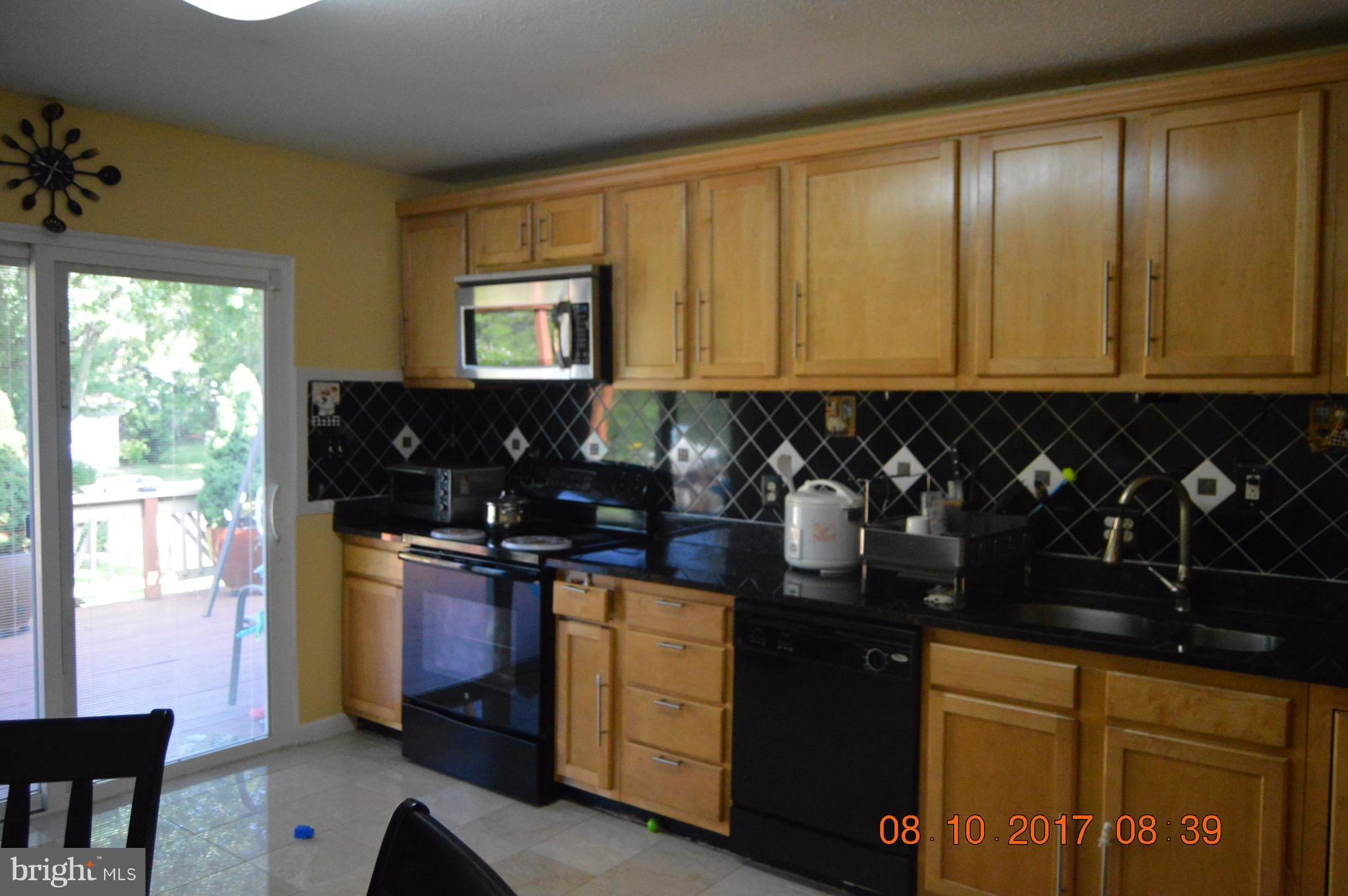 17 Rollwin Road Baltimore, MD 21244 - Photo 11 of 29 a kitchen with a refrigerator and window
