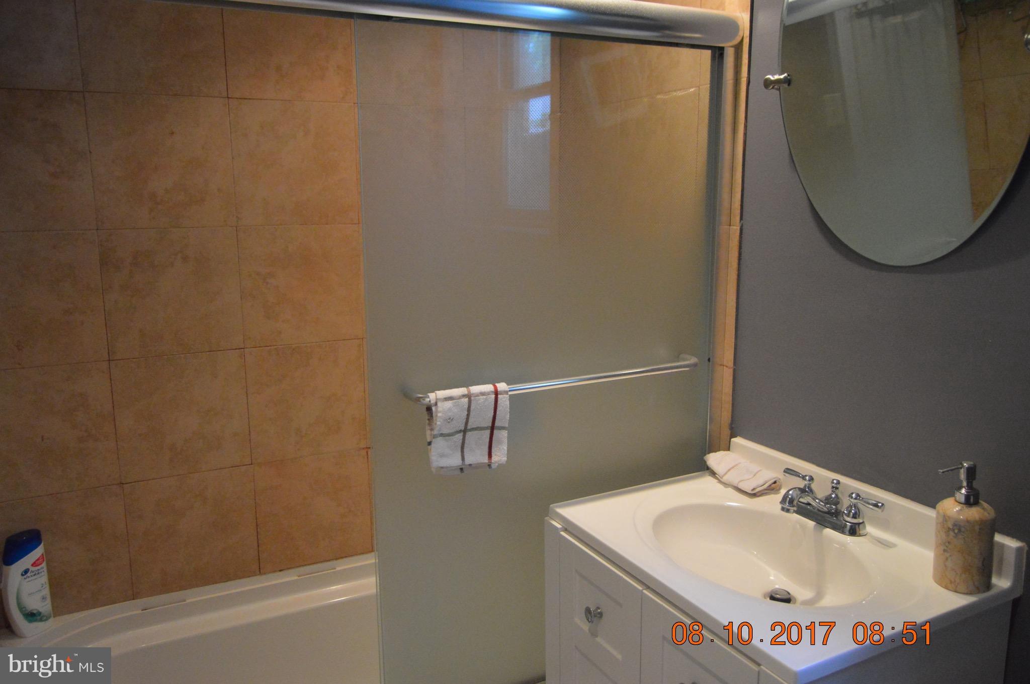 17 Rollwin Road Baltimore, MD 21244 - Photo 19 of 29 a bathroom with a sink and mirror