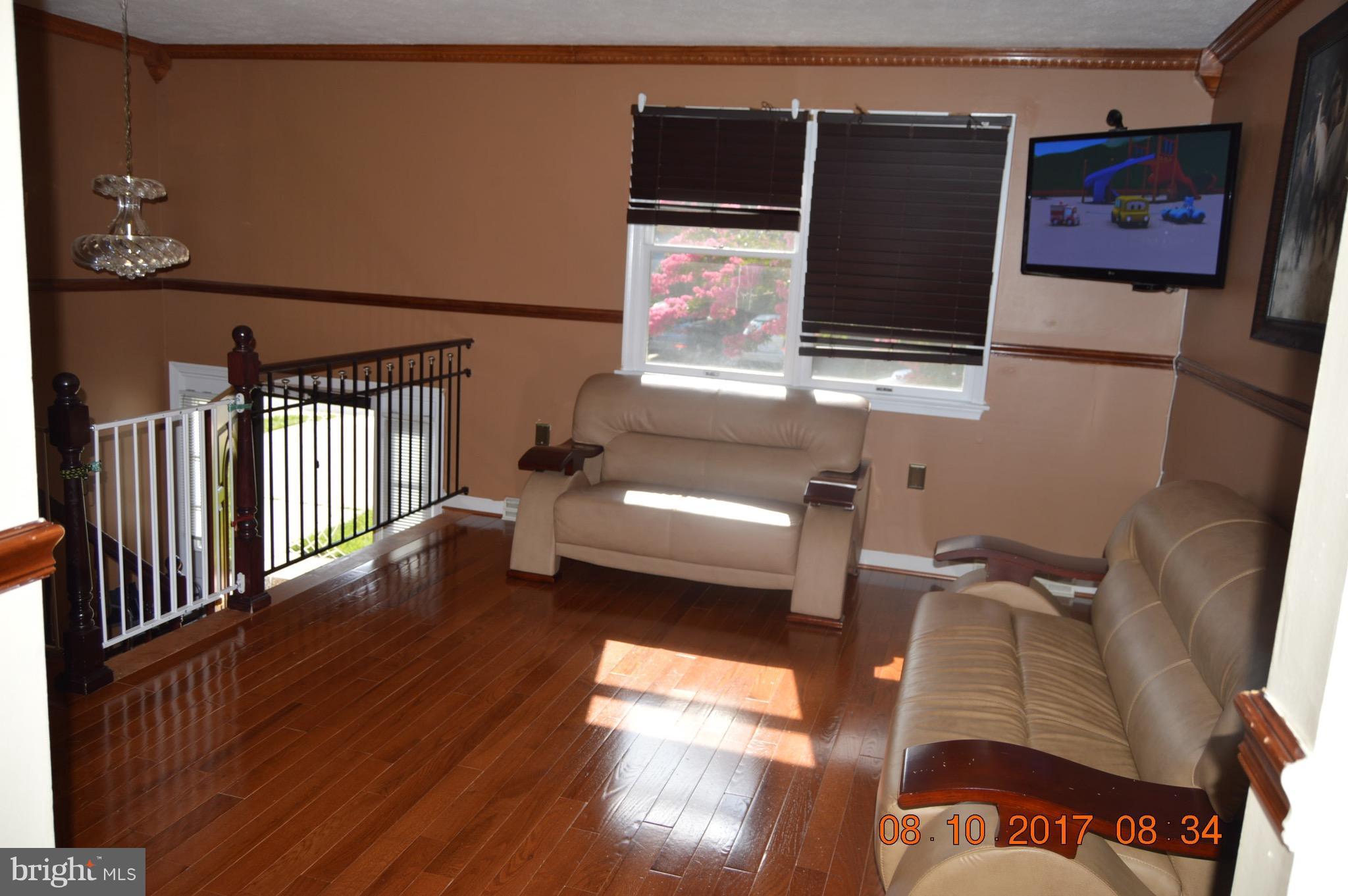 17 Rollwin Road Baltimore, MD 21244 - Photo 6 of 29 a living room with furniture and a flat screen tv