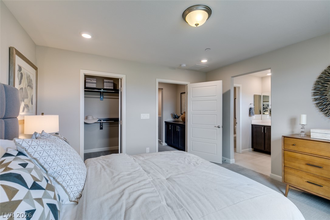 653 Pickled Pepper Place Henderson, NV 89011 - Photo 27 of 35 A well-appointed bedroom suite offers a spacious closet and convenient access to an adjoining private bathroom.