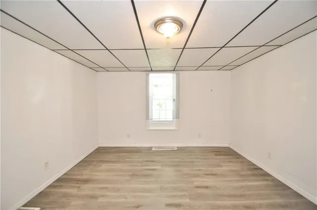 a view of a room with wooden floor and windows