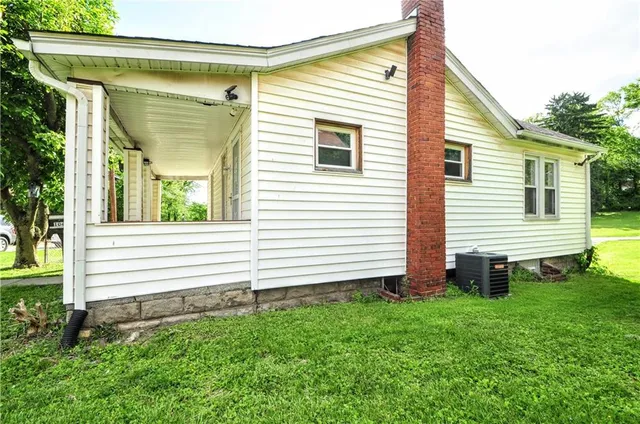 a view of a house with a yard and sitting area