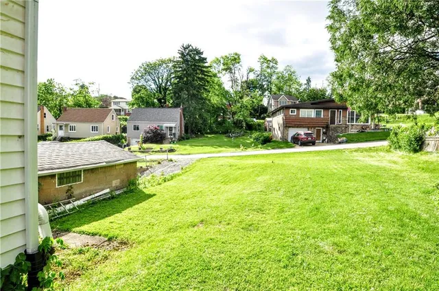 a view of a house with a yard and sitting area