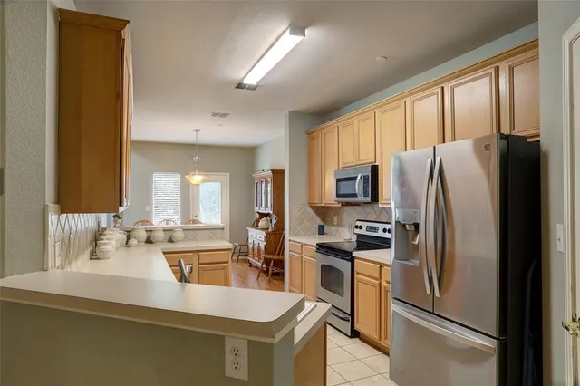 a kitchen with stainless steel appliances a refrigerator and a sink