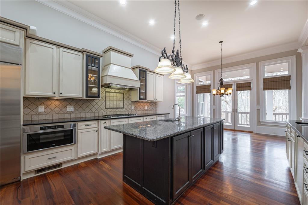 250 Frank Bruce Road Dawsonville, GA 30534 - Photo 20 of 110 a kitchen with stainless steel appliances granite countertop a sink a stove and wooden floor