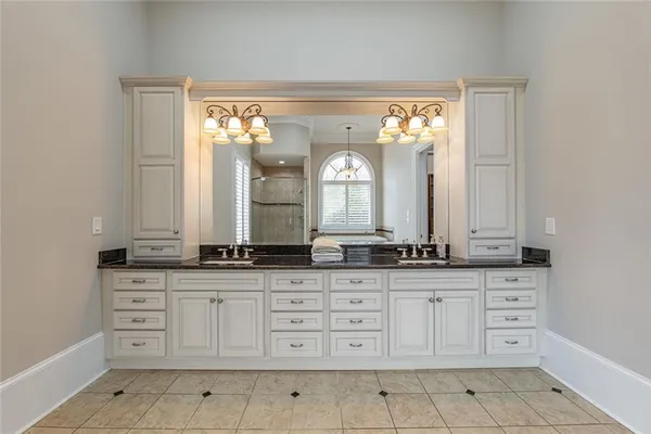 an empty room with windows and ceiling fan