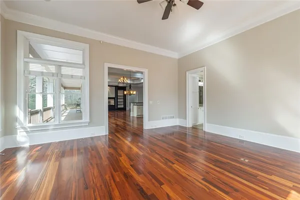 an empty room with closet and ceiling fan
