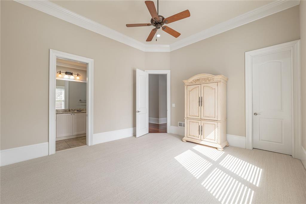 250 Frank Bruce Road Dawsonville, GA 30534 - Photo 38 of 110 a view of a livingroom with wooden floor and a ceiling fan