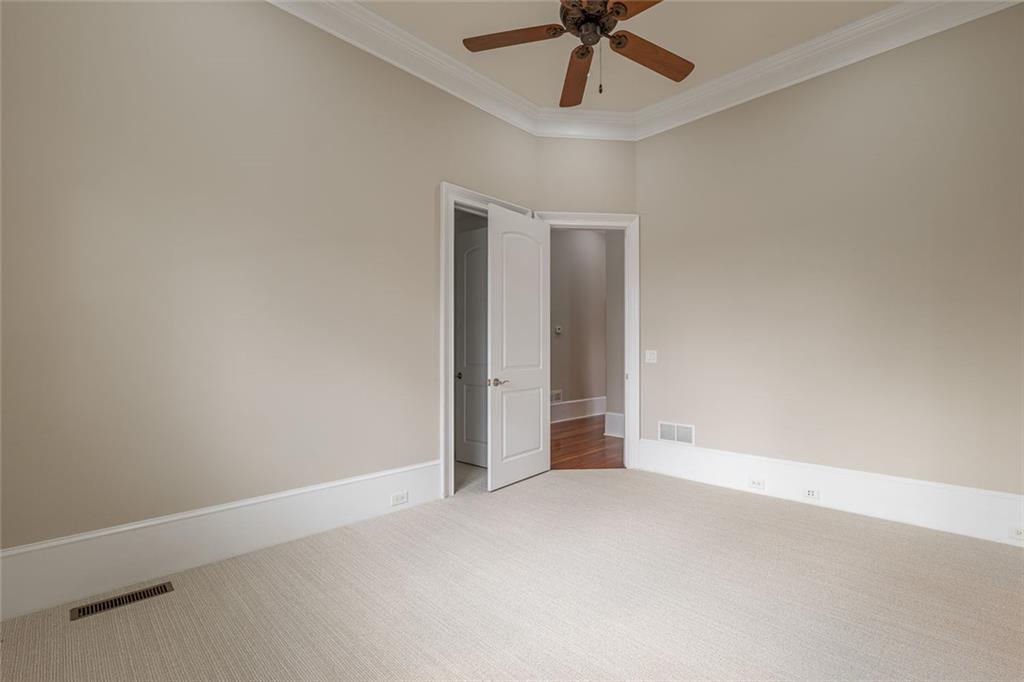 250 Frank Bruce Road Dawsonville, GA 30534 - Photo 40 of 110 an empty room with a ceiling fan and carpet
