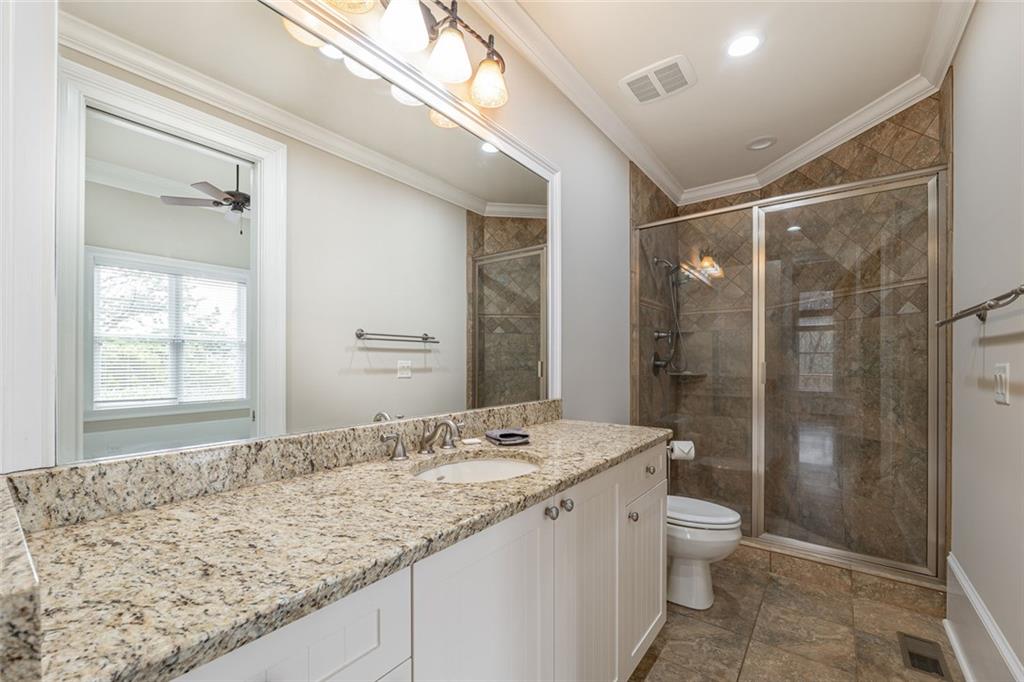250 Frank Bruce Road Dawsonville, GA 30534 - Photo 43 of 110 a bathroom with a granite countertop sink toilet and shower