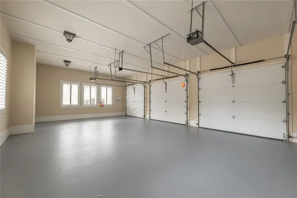 a view of a kitchen with stainless steel appliances wooden floor and brick wall