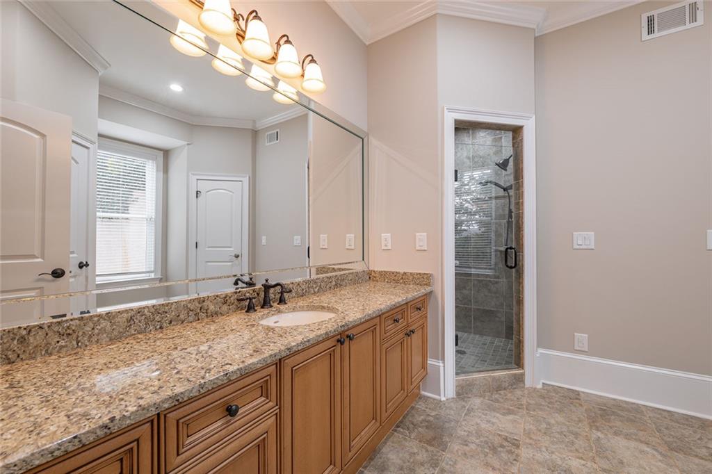 250 Frank Bruce Road Dawsonville, GA 30534 - Photo 58 of 110 a bathroom with a granite countertop double vanity sink and mirror