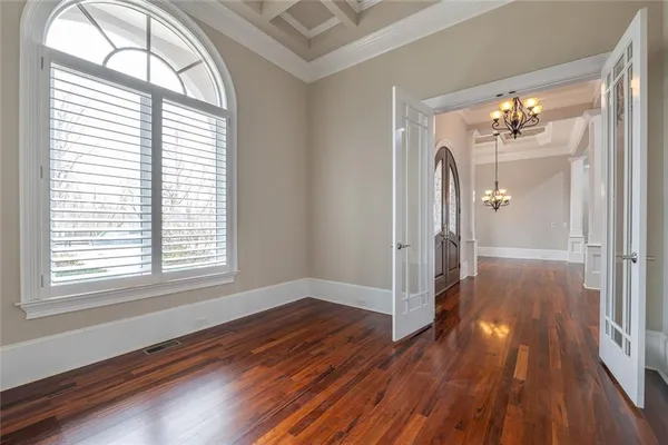 a view of an entryway and hall with wooden floor