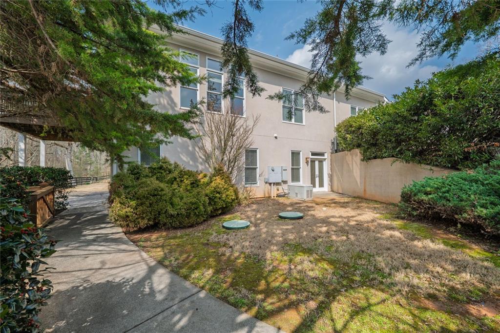 250 Frank Bruce Road Dawsonville, GA 30534 - Photo 82 of 110 a view of a white house with a yard and plants