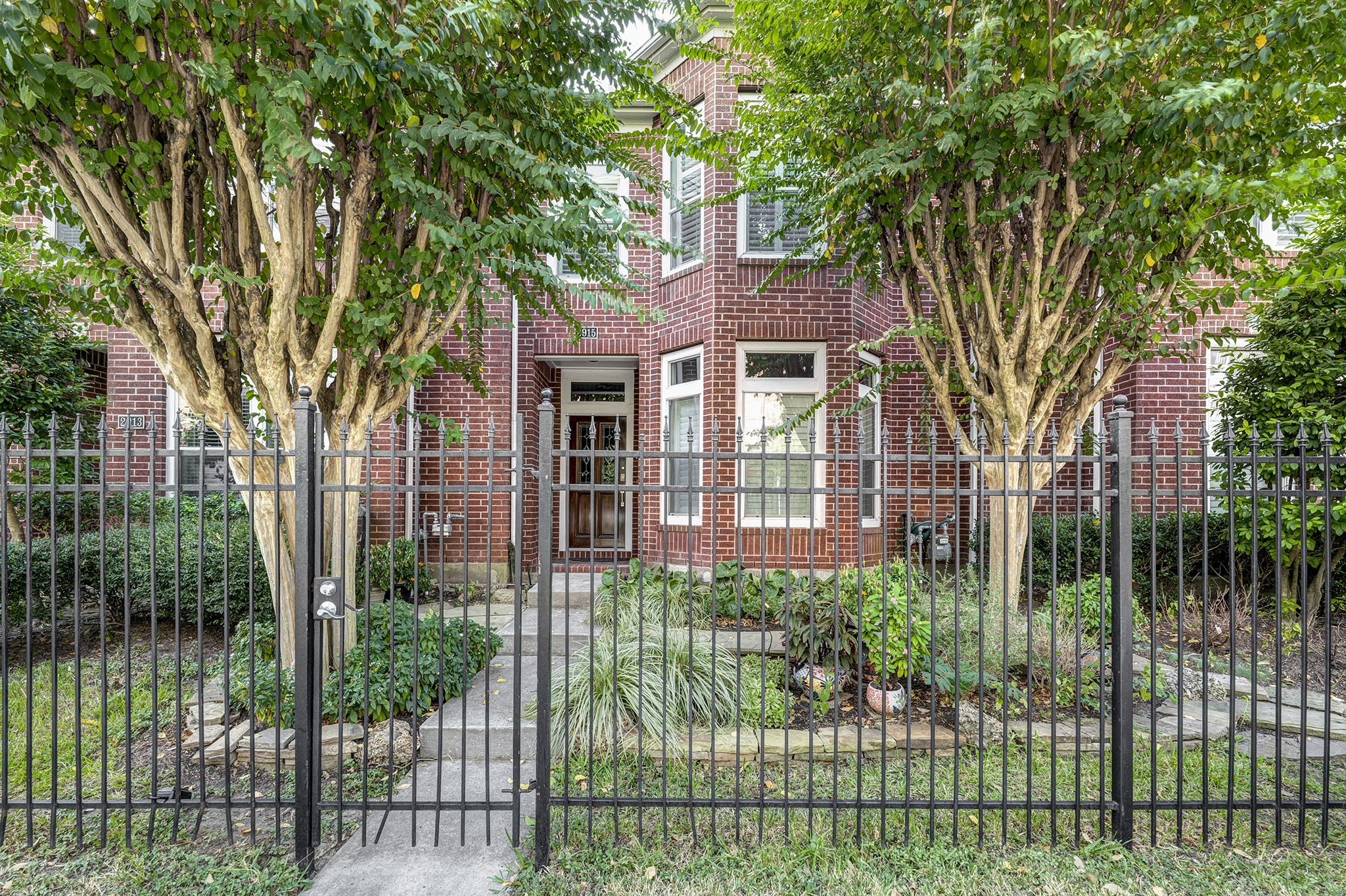 a front view of a house with a garden