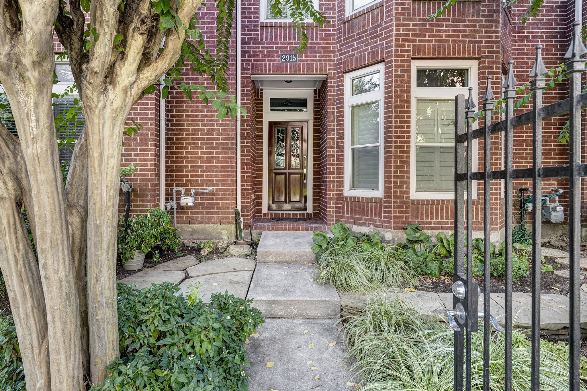 2915 West Dallas Street Houston, TX 77019 - Photo 2 of 17 a front view of a house with a yard and potted plants