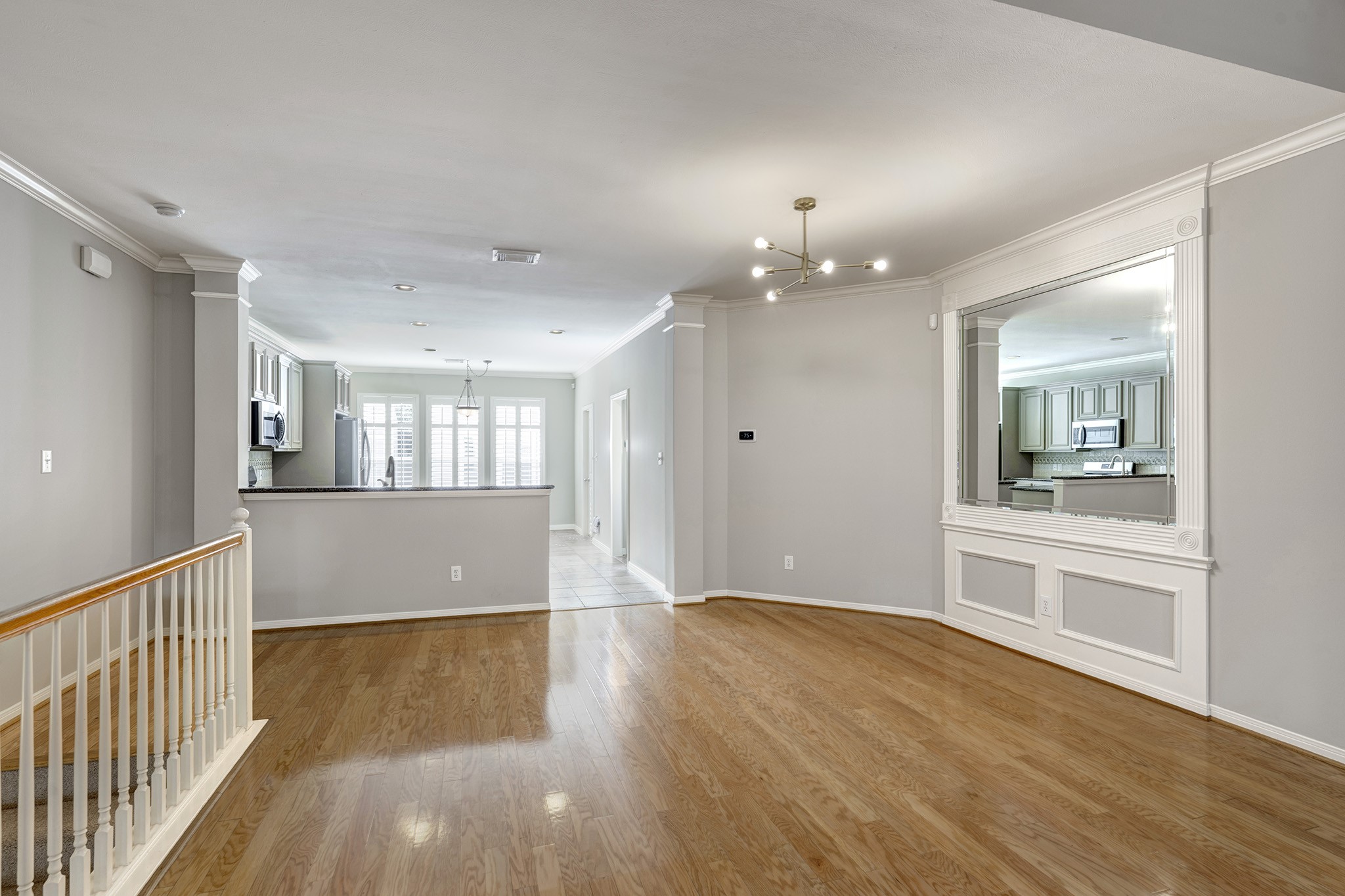 2915 West Dallas Street Houston, TX 77019 - Photo 7 of 17 a view of an empty room and kitchen with wooden floor