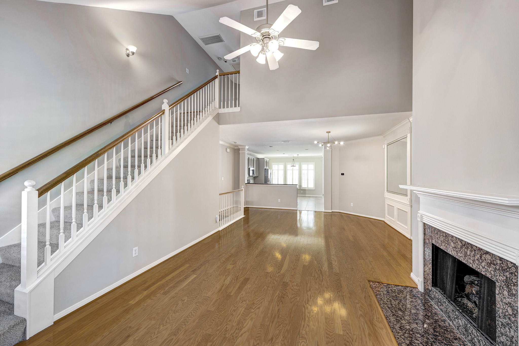 2915 West Dallas Street Houston, TX 77019 - Photo 9 of 17 a view of an empty room with wooden floor a ceiling fan and windows