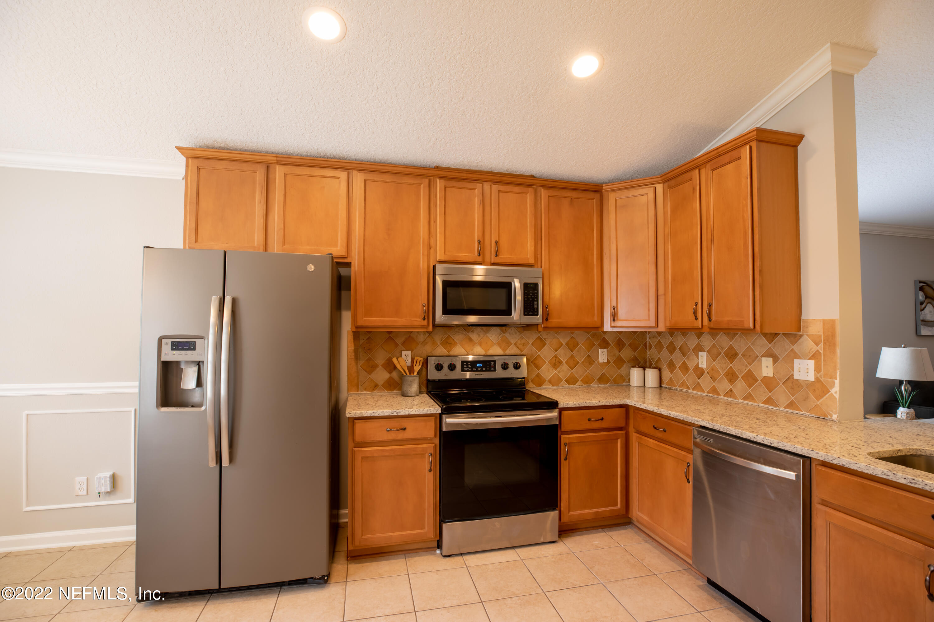 2067 North Cranbrook Avenue St. Augustine, FL 32092 - Photo 4 of 26 a kitchen with a sink a counter top space stainless steel appliances and cabinets
