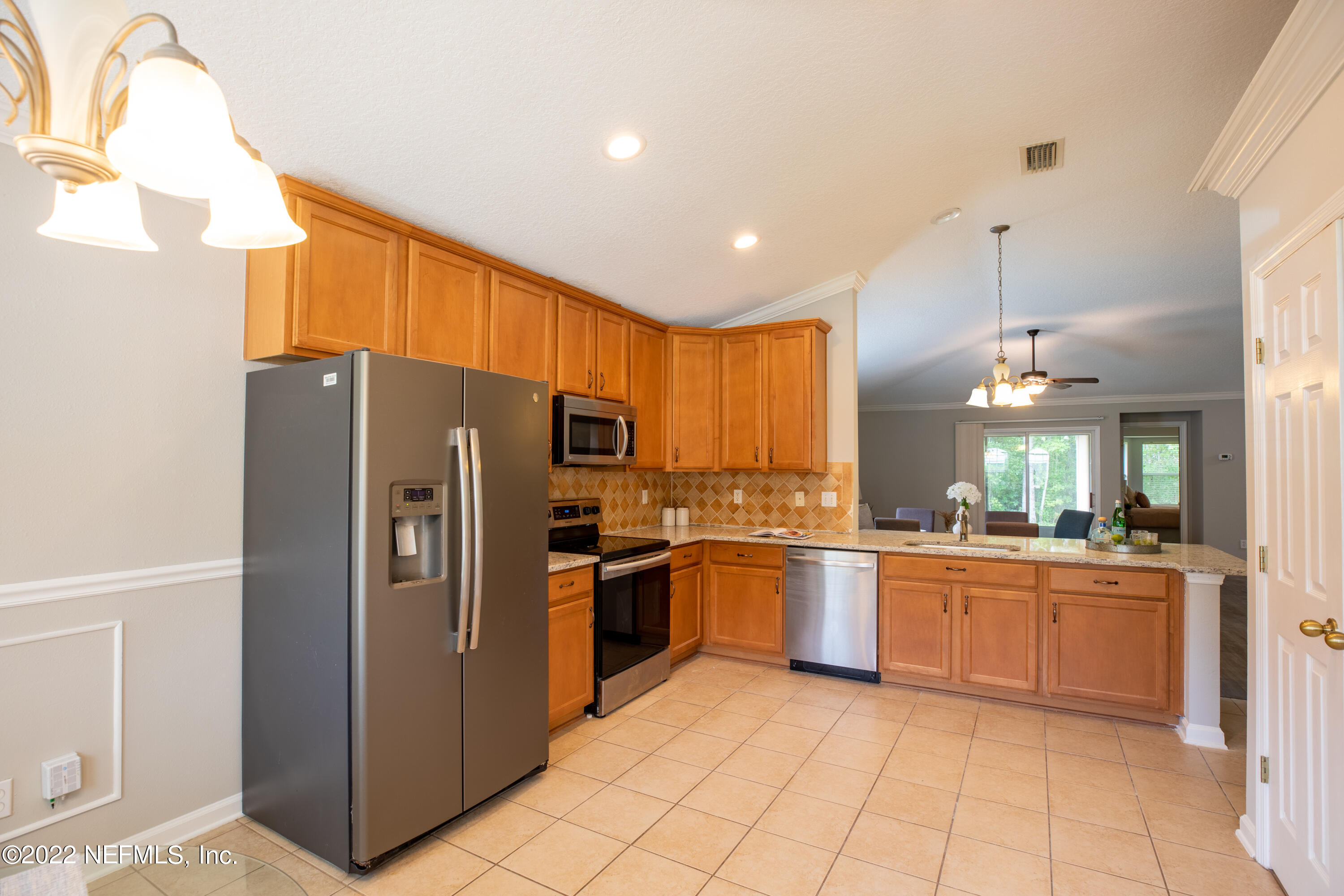 2067 North Cranbrook Avenue St. Augustine, FL 32092 - Photo 9 of 26 a kitchen with stainless steel appliances granite countertop a refrigerator and a stove top oven