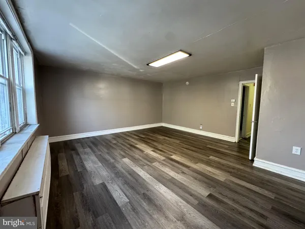 a view of room with window and wooden floor