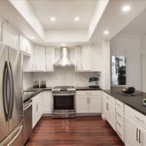 a kitchen with stainless steel appliances a refrigerator sink and stove