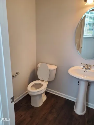 a white toilet sitting next to a bathroom sink