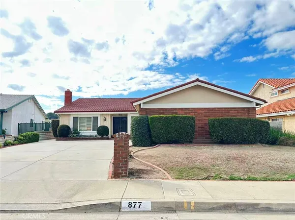 a front view of house with yard and trees