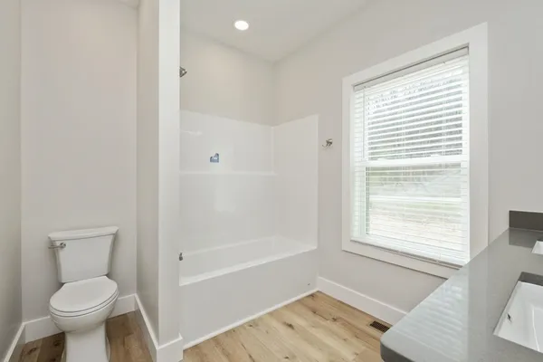 a bathroom with a toilet a sink and a bathtub