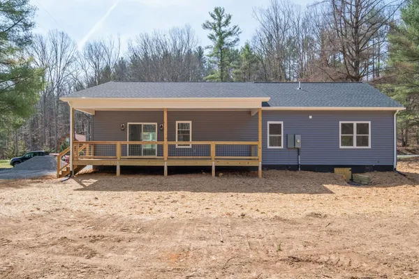 a view of a house with a yard covered in snow