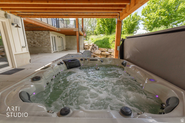 1188 South Old Trappers Loop Road Huntsville, UT 84317 - Photo 75 of 92 Outdoor hot tub with integrated lighting, set on a concrete patio