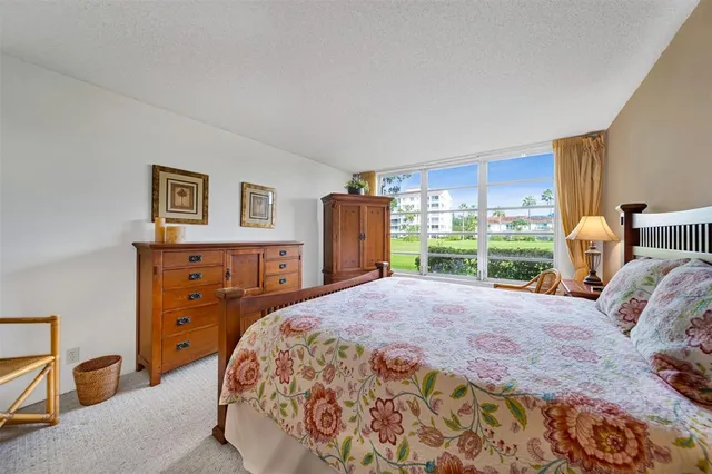 a bed room with a bed and a large window