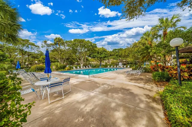 a outdoor space with lots of tables a garden view and chairs