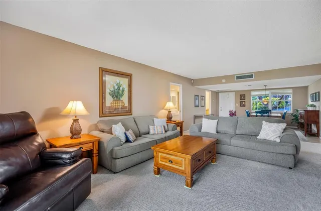 a living room with furniture and a lamp
