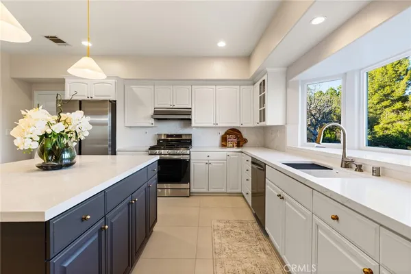 a kitchen with a sink stove and cabinets