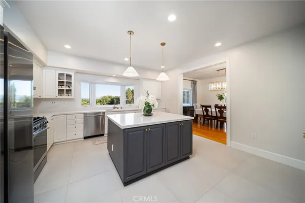 a large kitchen with a large counter top appliances and cabinets