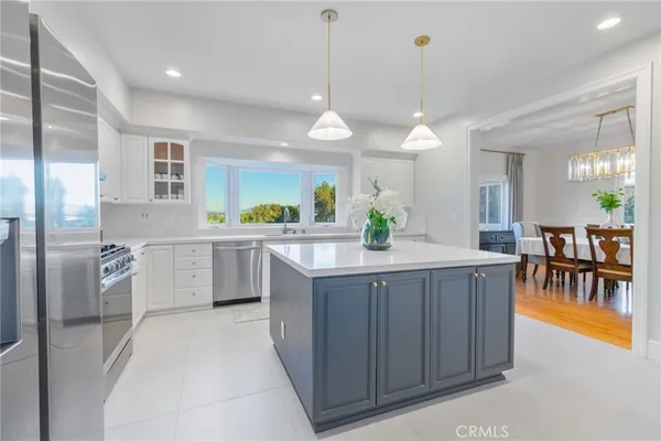 a kitchen with a table chairs sink and cabinets