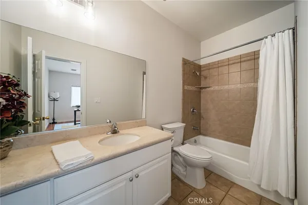 a bathroom with a granite countertop sink a toilet and shower