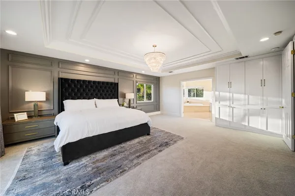 a bedroom with a large bed and a large window