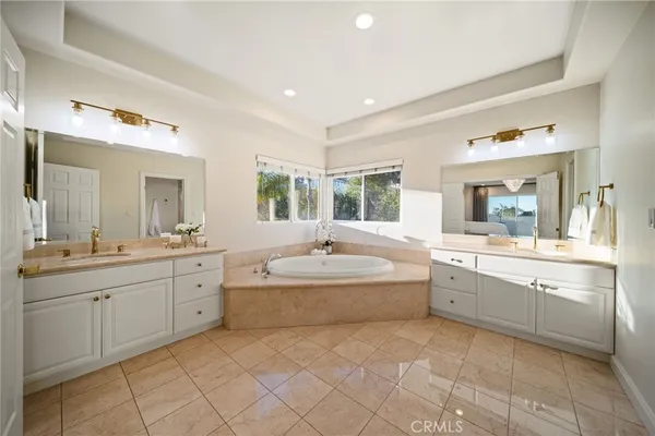 a large bathroom with a large tub sink shower double vanity