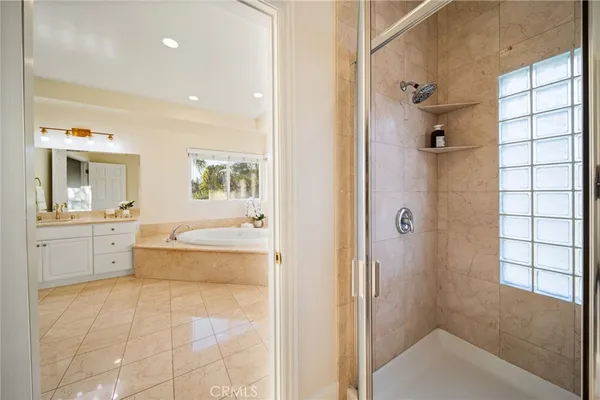 a bathroom with a tub shower and sink