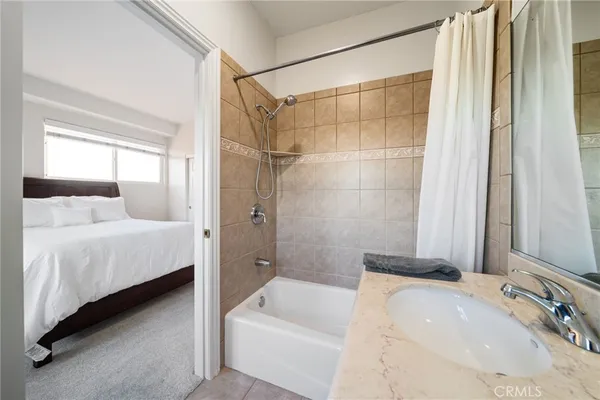 a bathroom with a tub sink and mirror